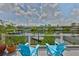 Waterfront deck with comfortable seating to enjoy the peaceful canal views at 920 Symphony Isles Blvd, Apollo Beach, FL 33572