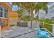 Outdoor kitchen with palm trees and an outdoor grill with seating area on a canal waterfront at 920 Symphony Isles Blvd, Apollo Beach, FL 33572