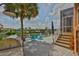Spacious outdoor deck overlooking the canal with two Adirondack chairs and an outdoor grill at 920 Symphony Isles Blvd, Apollo Beach, FL 33572
