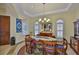 Well-lit dining room with a chandelier, tile flooring, and decorative window shutters at 920 Symphony Isles Blvd, Apollo Beach, FL 33572