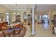 Bright dining room with tile floors, an elegant chandelier, and open access to multiple living spaces at 920 Symphony Isles Blvd, Apollo Beach, FL 33572