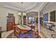 Elegant dining room featuring a chandelier, tile floors, and access to other living spaces at 920 Symphony Isles Blvd, Apollo Beach, FL 33572