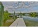 A serene view of the waterway showcasing a private boat dock with boats nearby at 920 Symphony Isles Blvd, Apollo Beach, FL 33572