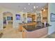 The open kitchen has a large island, stainless steel appliances and is adjacent to the living and dining rooms at 920 Symphony Isles Blvd, Apollo Beach, FL 33572