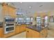 Spacious kitchen with stainless appliances, granite countertops and large island with sink at 920 Symphony Isles Blvd, Apollo Beach, FL 33572