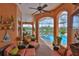 Relaxing lanai with comfortable seating overlooking a sparkling swimming pool and waterfront canal at 920 Symphony Isles Blvd, Apollo Beach, FL 33572