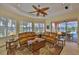 Sunlit living area with ceiling fan and access to the lanai with a pool view at 920 Symphony Isles Blvd, Apollo Beach, FL 33572