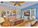Open living space with kitchen access, a large entertainment center, and comfortable seating at 920 Symphony Isles Blvd, Apollo Beach, FL 33572