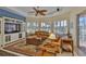 Inviting living room with large windows, ceiling fan, and a comfortable seating arrangement at 920 Symphony Isles Blvd, Apollo Beach, FL 33572