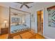 Main bedroom with ensuite bathroom, four poster bed, and wood floors at 920 Symphony Isles Blvd, Apollo Beach, FL 33572