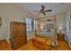 Main bedroom featuring a four poster bed, wooden floors, and windows with shutters at 920 Symphony Isles Blvd, Apollo Beach, FL 33572