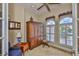 This home office features a decorative ceiling fan, custom shutters, and a built-in shelf for décor at 920 Symphony Isles Blvd, Apollo Beach, FL 33572