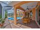 Relaxing outdoor patio with a ceiling fan, outdoor dining area and pool access at 920 Symphony Isles Blvd, Apollo Beach, FL 33572