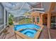 Beautiful screened-in pool and spa area on a sunny day, offering an amazing outdoor living space at 920 Symphony Isles Blvd, Apollo Beach, FL 33572