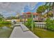 Waterfront home with dock, screened lanai and tropical landscaping, perfect for enjoying outdoor living at 920 Symphony Isles Blvd, Apollo Beach, FL 33572
