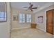 Bright room with tile flooring, wooden door, and plantation shutters at 920 Symphony Isles Blvd, Apollo Beach, FL 33572
