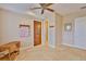 Spacious room featuring tile floors, a wooden door, and a small cart at 920 Symphony Isles Blvd, Apollo Beach, FL 33572