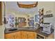 This kitchen area boasts a custom wine rack and wine glass holder as well as a built-in wine fridge at 920 Symphony Isles Blvd, Apollo Beach, FL 33572