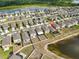 Aerial view of a house with a fenced backyard that backs up to a lake at 9423 Lemon Drop Loop, Sun City Center, FL 33573