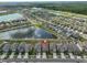 An aerial view showing the neighborhood layout, lakes and houses at 9423 Lemon Drop Loop, Sun City Center, FL 33573