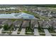 An aerial view of homes next to a retention pond with a blue sky reflection at 9423 Lemon Drop Loop, Sun City Center, FL 33573