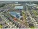 An aerial view showing neighborhood, retention ponds, and green spaces at 9423 Lemon Drop Loop, Sun City Center, FL 33573