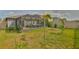 Backyard featuring a screened-in porch and a pond view at 9423 Lemon Drop Loop, Sun City Center, FL 33573