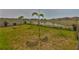 Spacious backyard featuring a white fence and a pond view at 9423 Lemon Drop Loop, Sun City Center, FL 33573
