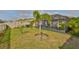 Backyard featuring a screened-in porch and manicured landscaping at 9423 Lemon Drop Loop, Sun City Center, FL 33573