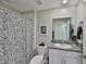 Bathroom showcasing a single sink vanity and a shower with a decorative curtain at 9423 Lemon Drop Loop, Sun City Center, FL 33573