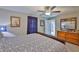 Comfortable bedroom showcasing a wood dresser and decor, filled with natural light at 9423 Lemon Drop Loop, Sun City Center, FL 33573
