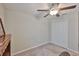 Neutral bedroom featuring a ceiling fan and bi-fold closet doors at 9423 Lemon Drop Loop, Sun City Center, FL 33573