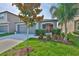 Charming single-story home featuring a well-manicured lawn and colorful landscaping at 9423 Lemon Drop Loop, Sun City Center, FL 33573