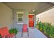 Cozy front porch with seating, offering a welcoming entrance to the home at 9423 Lemon Drop Loop, Sun City Center, FL 33573