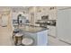Spacious kitchen with granite counters, island with seating, and stainless appliances at 9423 Lemon Drop Loop, Sun City Center, FL 33573