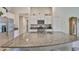 Large kitchen island features granite countertop and stainless steel appliances at 9423 Lemon Drop Loop, Sun City Center, FL 33573