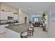 Open-concept kitchen with granite countertops and stainless steel appliances, flowing into the living area at 9423 Lemon Drop Loop, Sun City Center, FL 33573