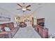 Spacious living room with ceiling fan, plush seating, and neutral decor at 9423 Lemon Drop Loop, Sun City Center, FL 33573