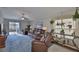 Living room with ceiling fan, leather reclining furniture, and sliding glass doors at 9423 Lemon Drop Loop, Sun City Center, FL 33573