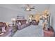 Open living room with leather seating, ceiling fan, and view to the kitchen at 9423 Lemon Drop Loop, Sun City Center, FL 33573
