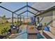 Well-furnished screened-in porch provides a comfortable outdoor living space at 9423 Lemon Drop Loop, Sun City Center, FL 33573
