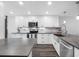 Bright kitchen features white cabinetry, stainless steel appliances, subway tile backsplash and dark countertops at 9450 Harbor Greens Way # 207, Seminole, FL 33776