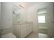 Bright bathroom features double vanity, ample lighting, and doorway to bedroom at 9512 Summers Cay Cir, Thonotosassa, FL 33592