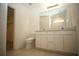 Well-lit bathroom showcasing a double vanity and a view into the tiled shower at 9512 Summers Cay Cir, Thonotosassa, FL 33592