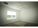 Bedroom with a ceiling fan, carpet, and a window providing natural light and yard views at 9512 Summers Cay Cir, Thonotosassa, FL 33592