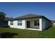 Back exterior showcasing covered patio, sliding doors and neat landscaping at 9512 Summers Cay Cir, Thonotosassa, FL 33592