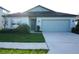 Charming single-story home with well-manicured lawn and an attached two-car garage at 9512 Summers Cay Cir, Thonotosassa, FL 33592