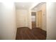 Bright foyer with dark wood floors and white walls leading to other rooms at 9512 Summers Cay Cir, Thonotosassa, FL 33592