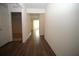 Long hallway featuring dark wood floors, white trim and neutral-toned walls at 9512 Summers Cay Cir, Thonotosassa, FL 33592