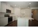 Bright kitchen with white cabinetry, stainless steel appliances and large center island at 9512 Summers Cay Cir, Thonotosassa, FL 33592